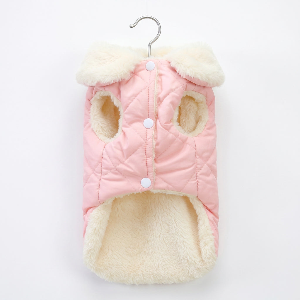 Pink and cream quilted dog coat on a hanger against a white background