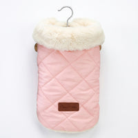 Pink quilted dog coat with white fur lining on a hanger against a white background