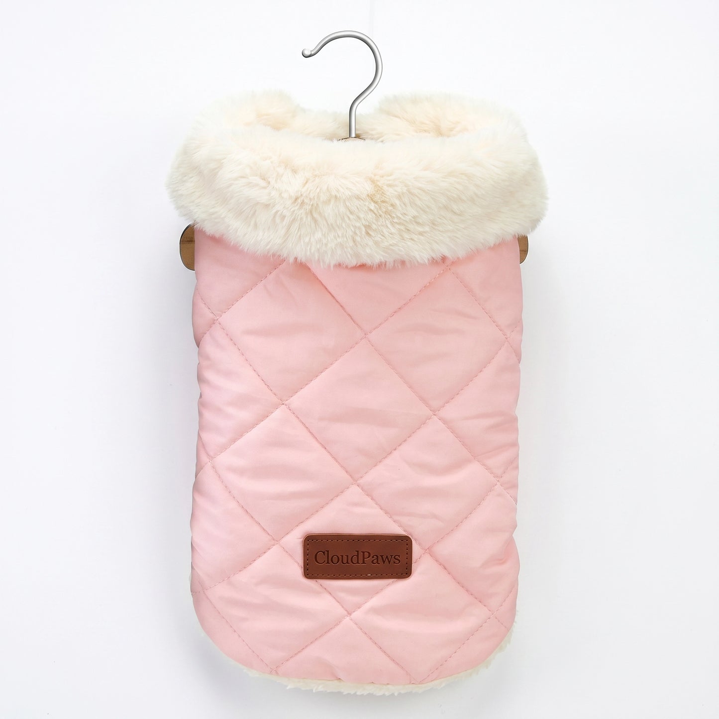 Pink quilted dog coat with white fur lining on a hanger against a white background