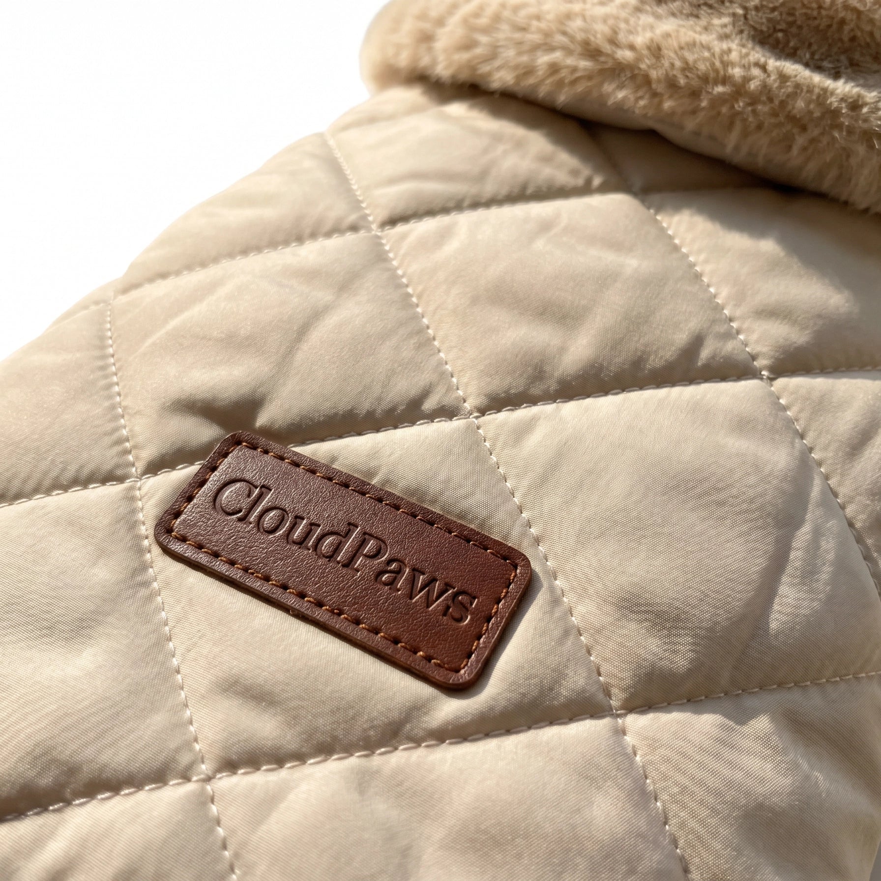 Beige quilted pet coat with a brown 'CloudPaws' label on a white background